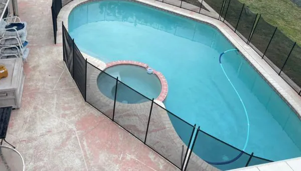 A clean pool deck around a kidney-shaped pool
