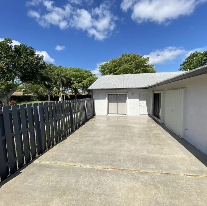 A clean concrete driveway beside a garage